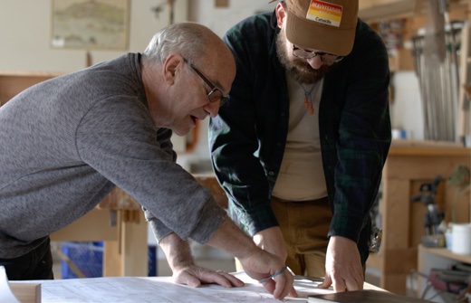 William & John working looking at plans